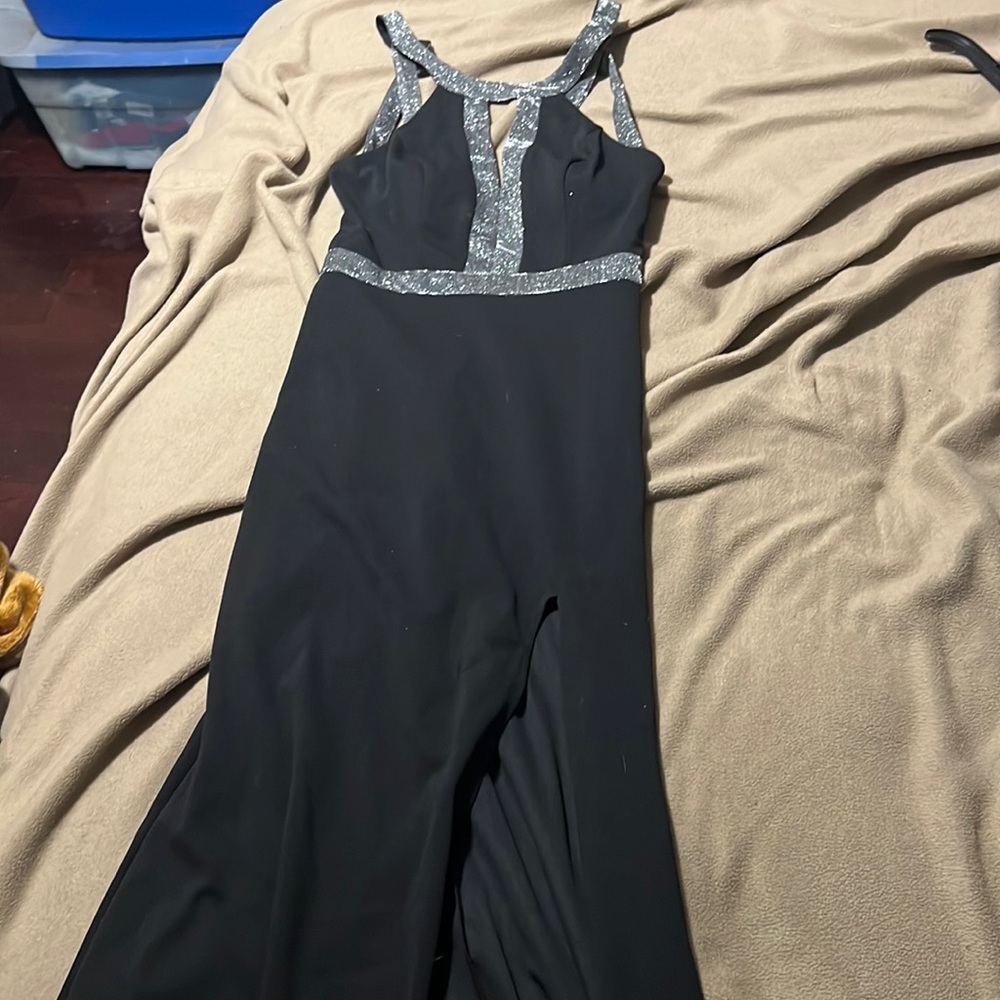 Long black dress with almost open back and a slit in the left leg.